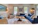 A bright living room featuring a large blue sofa, patterned rug, and windows that let in natural light at 203 Broad St., Georgetown, SC 29440