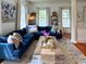 A cozy living room features a comfortable blue sofa, hardwood floors, and neutral colored patterned rug at 203 Broad St., Georgetown, SC 29440