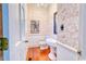 Elegant powder room featuring designer wallpaper, pedestal sink, and stylish fixtures at 203 Broad St., Georgetown, SC 29440
