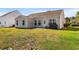 View of the home's backyard with a patio and green grass at 2336 Windmill Way, Myrtle Beach, SC 29579