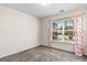Cozy bedroom with plush carpeting, a large window, and coral-patterned curtains at 2336 Windmill Way, Myrtle Beach, SC 29579