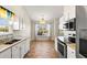 Bright eat-in kitchen with a window and breakfast nook, stylish light fixture, and stainless steel appliances at 2336 Windmill Way, Myrtle Beach, SC 29579