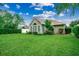 Backyard with manicured lawn and well-maintained home exterior at 24 Willowbend Dr., Murrells Inlet, SC 29576