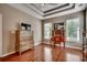 Spacious bedroom featuring hardwood floors, a tray ceiling, and abundant natural light at 24 Willowbend Dr., Murrells Inlet, SC 29576