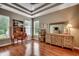 Bedroom with hardwood floors, tray ceiling, ample natural light, and decorative accents at 24 Willowbend Dr., Murrells Inlet, SC 29576