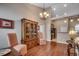 Bright dining area featuring hardwood floors, a chandelier, and seamless access to other rooms at 24 Willowbend Dr., Murrells Inlet, SC 29576