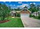 Well maintained brick home featuring a manicured lawn and landscaping with mature trees and an attached garage at 24 Willowbend Dr., Murrells Inlet, SC 29576