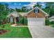 Charming brick home with attached garage, complemented by a well-manicured lawn and professional landscaping at 24 Willowbend Dr., Murrells Inlet, SC 29576