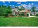 Well maintained brick home featuring a manicured lawn and landscaping with mature trees and an attached garage at 24 Willowbend Dr., Murrells Inlet, SC 29576