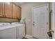 Laundry room with washer, dryer, storage cabinets, and access to the exterior at 24 Willowbend Dr., Murrells Inlet, SC 29576