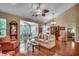 Spacious living room with hardwood floors, large windows, and elegant decor, perfect for gatherings at 24 Willowbend Dr., Murrells Inlet, SC 29576