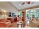 Cozy living room showcasing hardwood floors, a TV, and an open view into the dining area at 24 Willowbend Dr., Murrells Inlet, SC 29576