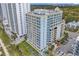Aerial view of a multi-story beachfront condo building with ample parking and a pool at 2501 S Ocean Blvd. # 111, Myrtle Beach, SC 29577