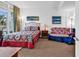 Well-lit bedroom with a full sized bed, small sofa, and floor lamps at 2501 S Ocean Blvd. # 111, Myrtle Beach, SC 29577