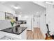 Modern kitchen with white cabinets, black countertops, and stainless steel appliances at 2501 S Ocean Blvd. # 111, Myrtle Beach, SC 29577