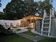 Backyard at dusk featuring a pergola, fire pit, above ground pool and relaxing lounge chairs at 2588 Long Avenue Ext., Conway, SC 29526