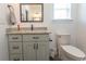 Bathroom featuring granite countertop, storage vanity, framed mirror, and elongated toilet at 2588 Long Avenue Ext., Conway, SC 29526