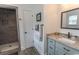 Bathroom with granite countertop, framed mirror and step-in tiled shower with built-in niche at 2588 Long Avenue Ext., Conway, SC 29526