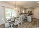 Bright dining area leading to the kitchen bar area, featuring a wooden table and updated lighting fixtures at 2588 Long Avenue Ext., Conway, SC 29526