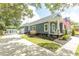 Charming home with a rocking chair front porch, an American flag, and a detached garage with a fenced yard at 2588 Long Avenue Ext., Conway, SC 29526