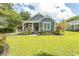 Inviting home exterior with a well-manicured lawn and lovely landscaping with a classic American flag on the porch at 2588 Long Avenue Ext., Conway, SC 29526