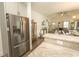 Open kitchen with granite counters and stainless steel fridge flows into living area at 2588 Long Avenue Ext., Conway, SC 29526