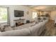Bright and airy living room featuring hardwood floors, a comfortable couch, and an open view into the dining area at 2588 Long Avenue Ext., Conway, SC 29526