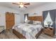 Primary bedroom with sliding barn door and wooden headboard at 2588 Long Avenue Ext., Conway, SC 29526