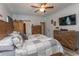 Comfortable bedroom featuring a wooden accent wall, barn door, and stylish gray patchwork quilt at 2588 Long Avenue Ext., Conway, SC 29526
