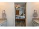 Main bedroom view from bathroom featuring wooden accent wall, barn door, and stylish gray patchwork quilt at 2588 Long Avenue Ext., Conway, SC 29526