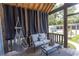 Covered patio with hammock swing, comfortable seating, outdoor curtains and a view of the backyard at 2588 Long Avenue Ext., Conway, SC 29526