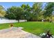 Large backyard with green grass, a white fence, mature trees and an outdoor play structure at 2595 Buck Scrape Rd., Myrtle Beach, SC 29588