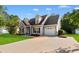 Attractive home with a well-maintained lawn and a long driveway leading to a one-car garage at 2595 Buck Scrape Rd., Myrtle Beach, SC 29588