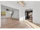 Spacious living room featuring hardwood floors leading to a kitchen, stairs, and front door at 2595 Buck Scrape Rd., Myrtle Beach, SC 29588