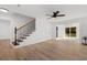 Open living room features hardwood flooring, ceiling fan and staircase at 2595 Buck Scrape Rd., Myrtle Beach, SC 29588