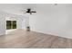 Bright living room featuring hardwood floors, a ceiling fan, and sliding glass doors to the backyard at 2595 Buck Scrape Rd., Myrtle Beach, SC 29588