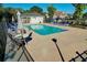 Community pool area with lounge chairs, tables, shade umbrellas and well-maintained landscaping at 2595 Buck Scrape Rd., Myrtle Beach, SC 29588