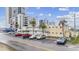 Low-rise yellow condo building with a parking lot and palm trees in an urban beach area at 2600 S Ocean Blvd. # 108, Myrtle Beach, SC 29577