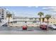 Low-rise yellow condo building with white balconies and palm trees in an urban beach area at 2600 S Ocean Blvd. # 108, Myrtle Beach, SC 29577