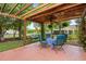 Backyard patio showing a wooden pergola with outdoor seating and backyard swing at 2636 Brick Dr., Longs, SC 29568