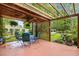 Relaxing backyard patio features a wooden pergola with outdoor seating and lovely landscaping at 2636 Brick Dr., Longs, SC 29568