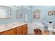 Well-lit bathroom with double sink vanity, jacuzzi tub and oak cabinets at 2636 Brick Dr., Longs, SC 29568