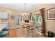 Cozy breakfast nook with a table, chairs, and a sliding glass door leading to a sunroom at 2636 Brick Dr., Longs, SC 29568