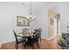 Formal dining room features hardwood floors, chandelier, seating for four at 2636 Brick Dr., Longs, SC 29568