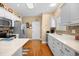Spacious kitchen with white cabinets, stainless steel appliances, and a breakfast bar at 2636 Brick Dr., Longs, SC 29568