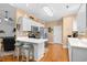 Bright kitchen featuring white cabinets, stainless steel appliances, and a breakfast bar with stools at 2636 Brick Dr., Longs, SC 29568