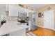 Well-lit kitchen featuring white cabinets, stainless steel appliances, and breakfast bar at 2636 Brick Dr., Longs, SC 29568