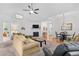 A living room showing an open floor plan with a fireplace, plush seating, and vaulted ceilings at 2636 Brick Dr., Longs, SC 29568