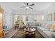 Living room with lots of natural light, a comfortable gray sofa, and a decorative rug at 2636 Brick Dr., Longs, SC 29568