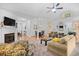 Bright living room with a fireplace, plush seating, and an open floor plan to the dining area at 2636 Brick Dr., Longs, SC 29568